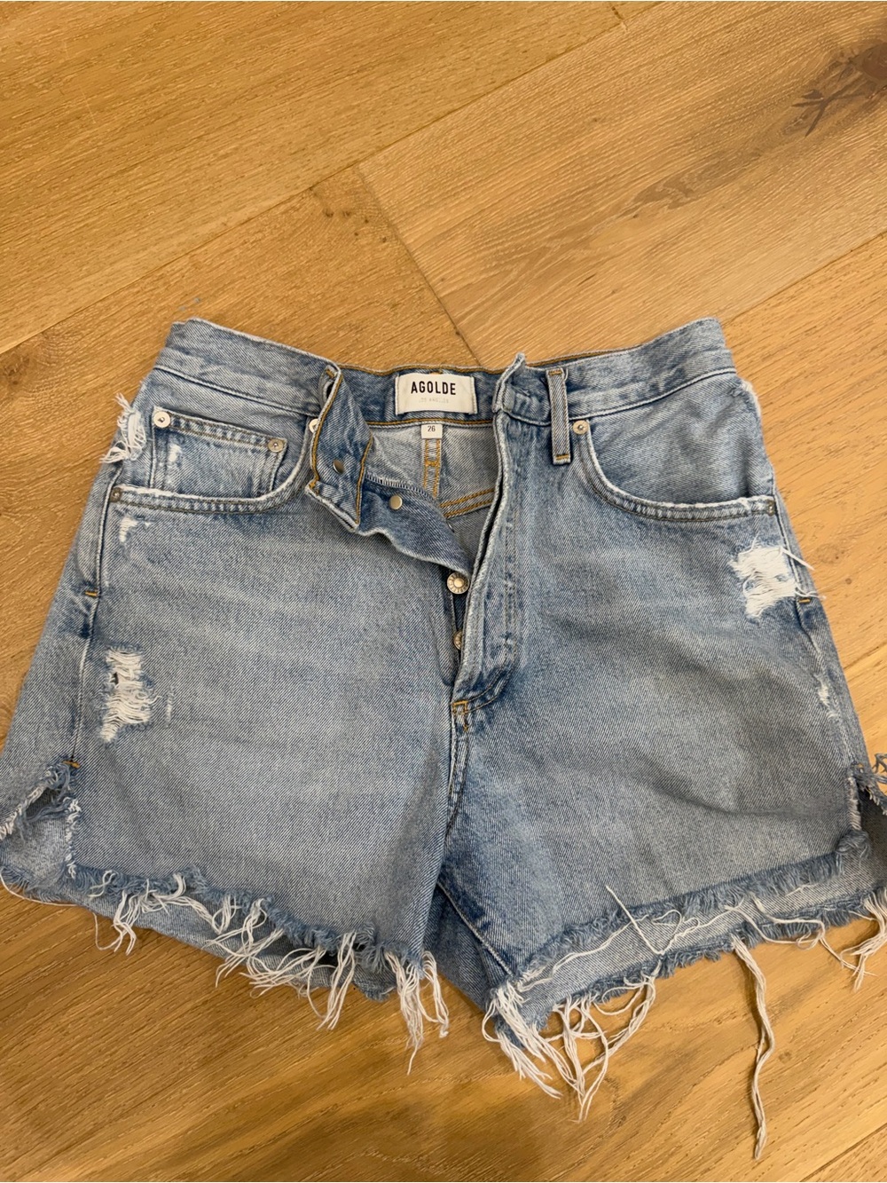 Agolde faded light blue distressed denim shorts